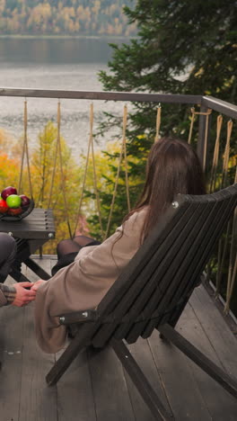 man with woman intertwines hands on terrace at twilight. setting provides idyllic backdrop for romantic retreat for couple among lavish and eco-friendly resort