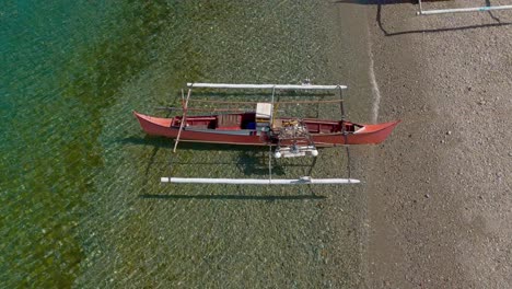 overhead drone view of fishing boats on bay of ipil shore, philippines