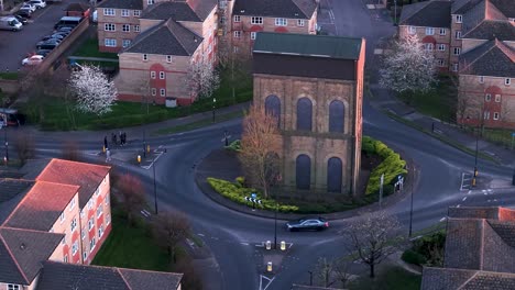 aerial view circling old water tank tower on enfield island village roundabout near london city