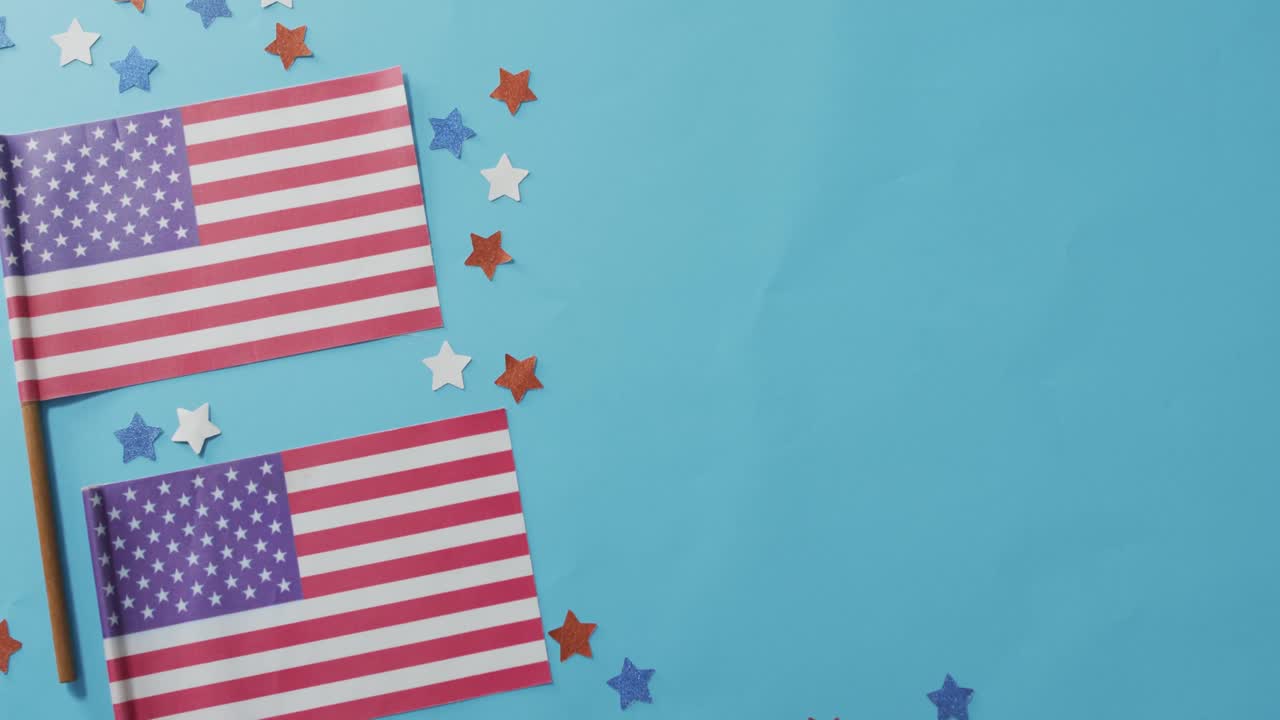 American flags with red and blue stars lying on blue background