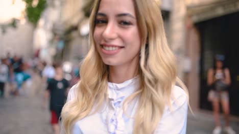 Attractive-young-beautiful-girl-waves-Turkish-flag-and-pulls-arm-of-her-boyfriend-at-narrow-street-in-Istanbul,Turkey