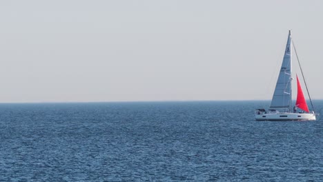 a sailboat moves across the ocean