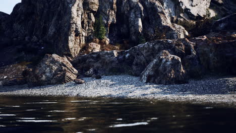 stunning view of a lake with rocks and cliffs in the background