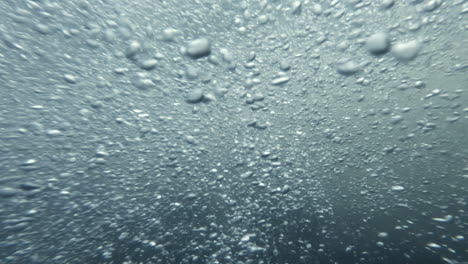 underwater footage, air bubbles in mountain river with clear water,stream flowing over stones,