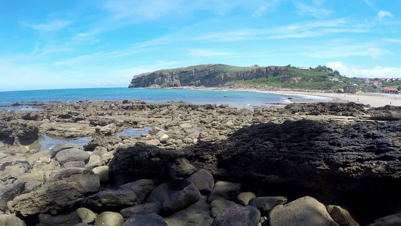 Rocky coastline and turquoise sea at Luaña Beach, Cóbreces, Cantabrian Sea, Spain