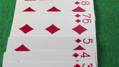 the camera moves across a deck of cards laid out on a casino table 1