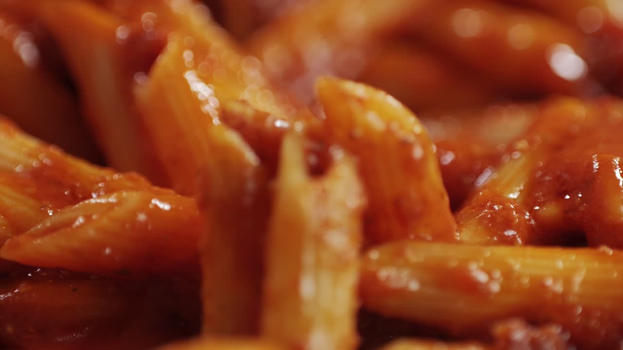 Cooking traditional arrabbiata pasta, penne with tomato sauce close-up. Cook classic homemade Italian tomato sauce for pasta and pizza in the pan. Chef cooks traditional Italian food. High quality 4k footage