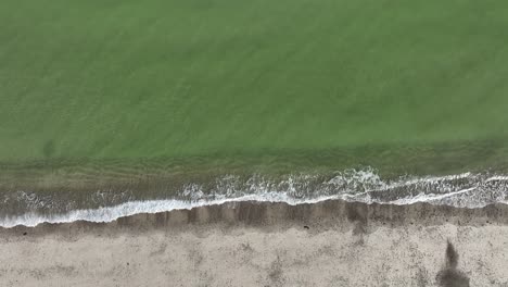 aerial view of a serene beach with calm waves