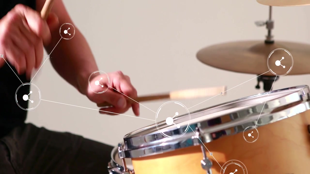 Drummer starting on poised sticks, playing fast strokes while white nodes tracking motion for music