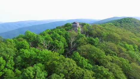 Push-in-aerial-of-fire-watch-tower-in-mountains