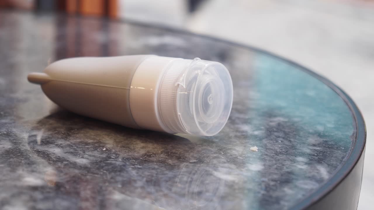 Gray plastic bottle on a marble table