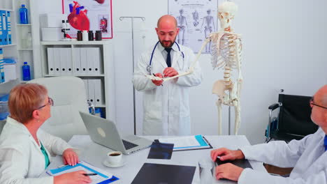 expert doctor analysing radiography using human skeleton