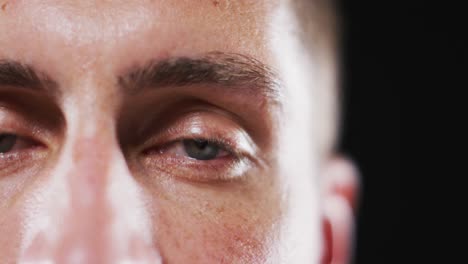 close up portrait of face of caucasian man with focus on blinking eye