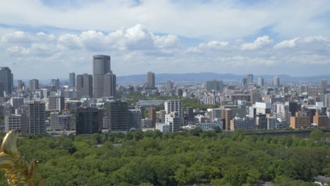 city high-rise buildings near osaka castle park in osaka, japan. aerial wide shot