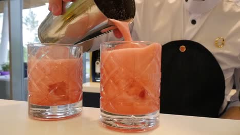 bartender preparing pink cocktails