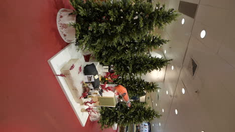 glowing christmas tree and gift in barcelona mall, vertical view