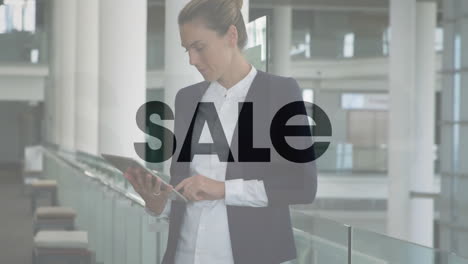 sale text animation over businesswoman using tablet in modern office