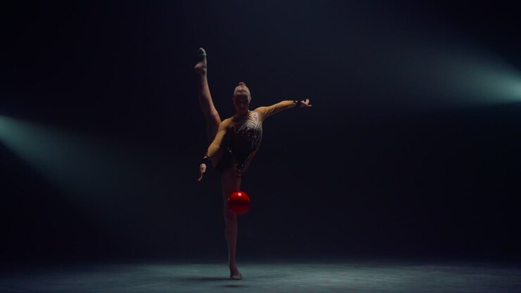 Pretty woman having workout with ball indoors. Gymnast doing calisthenics.