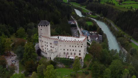 Aerial-View-Of-Castle-Bruck-Beside-River-Isel-In-Austria