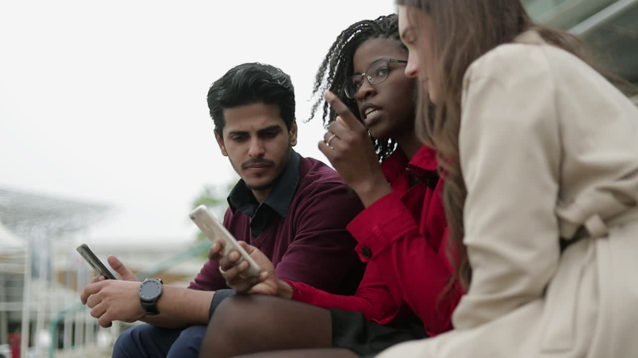 밖에서 앉아서  ⁇ 드폰으로 구글을 검색하는 젊은이들
