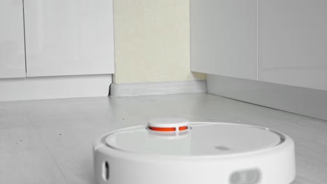 close-up of a robot vacuum cleaner picking up debris on the floor