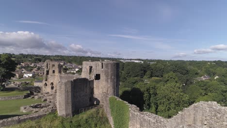 aerial rise up shot looking north west over bernard castle walls, revealing the town and trees