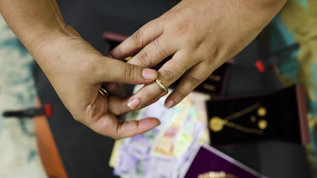 Female hand showcasing luxury ornamentation over defocused Indian currency notes