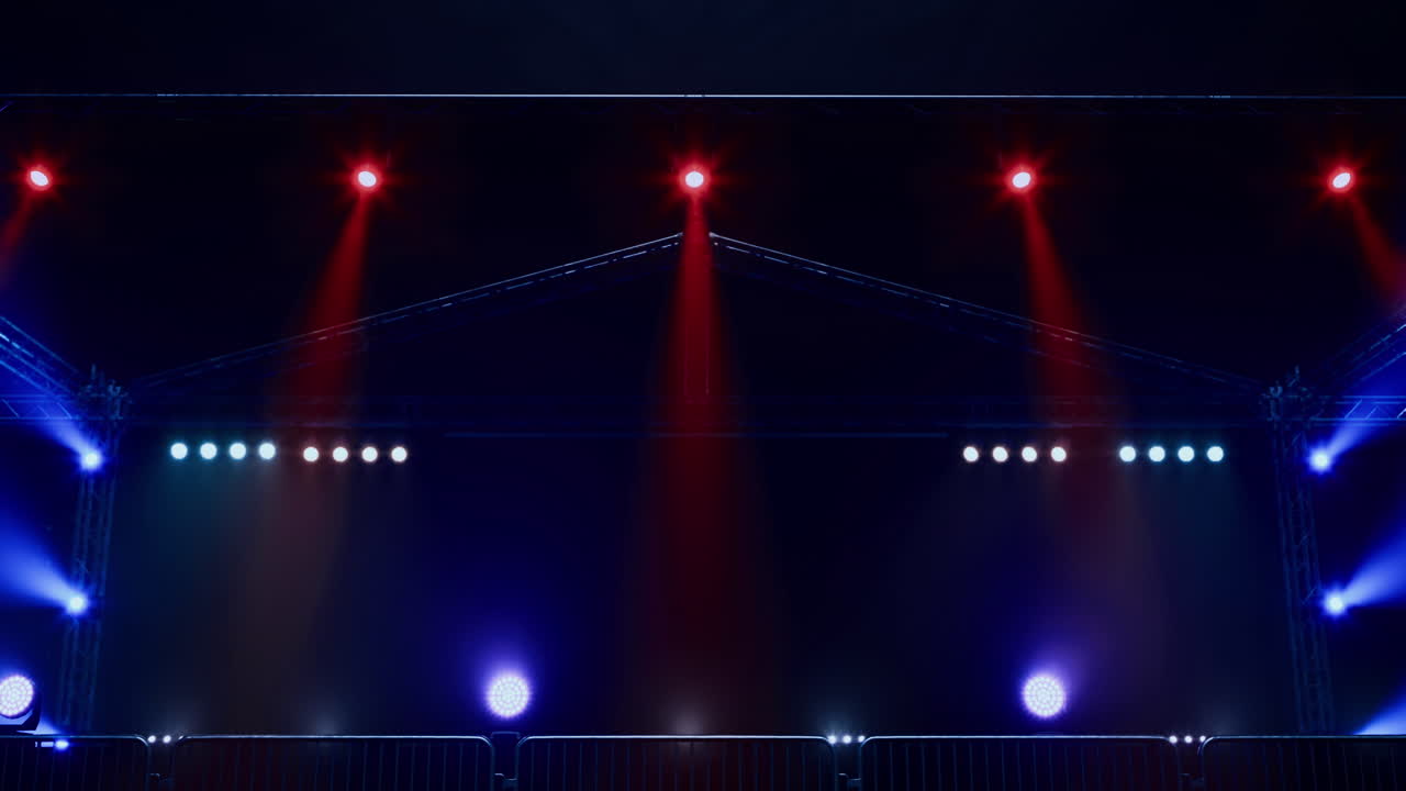 Event stage setup with lighting effects in a dark venue before showtime