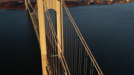 aerial view of cars on the verrazzano-narrows bridge, revealing the staten island, spring in sunny new york, usa - circling, tilt, drone shot