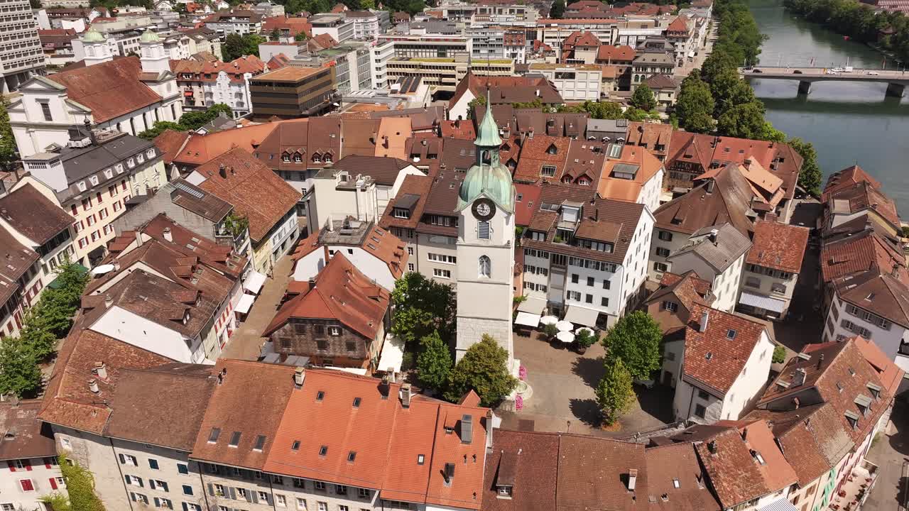 Olten’s historic old town aerial view with drone orbits around iconic clock tower and traditional red rooftops in summer