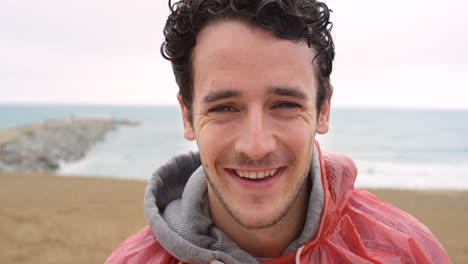 a happy young man smiling and enjoying a cold day