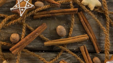 Falling-snow-with-Christmas-decorations-on-wood