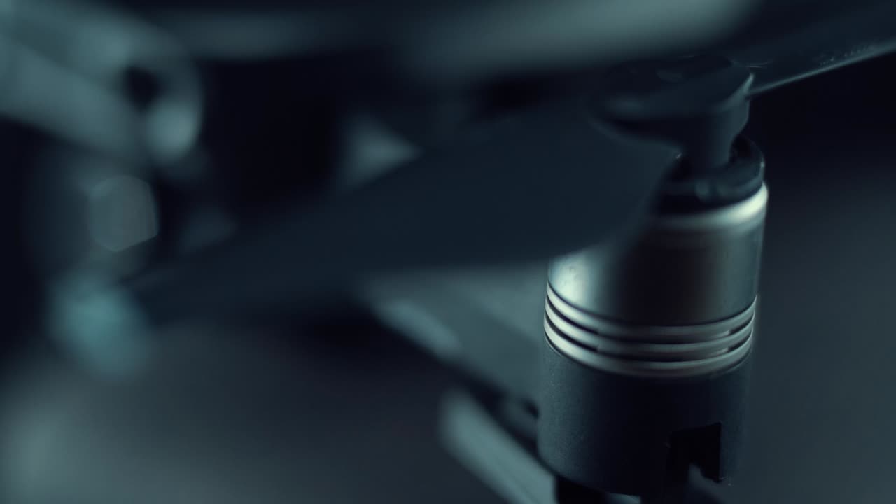 Macro Drone Camera propellers and sensors, hyper close up, aerial photography gear, professional film equipment, studio lighting, slide right movement, 120 fps slow motion