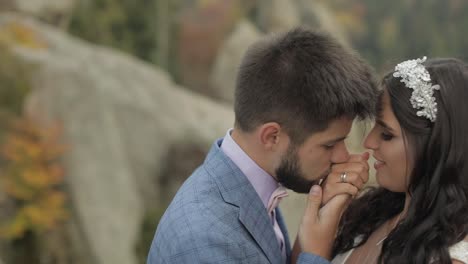 Groom-with-bride-on-a-mountain-hills-in-the-forest.-Wedding-couple