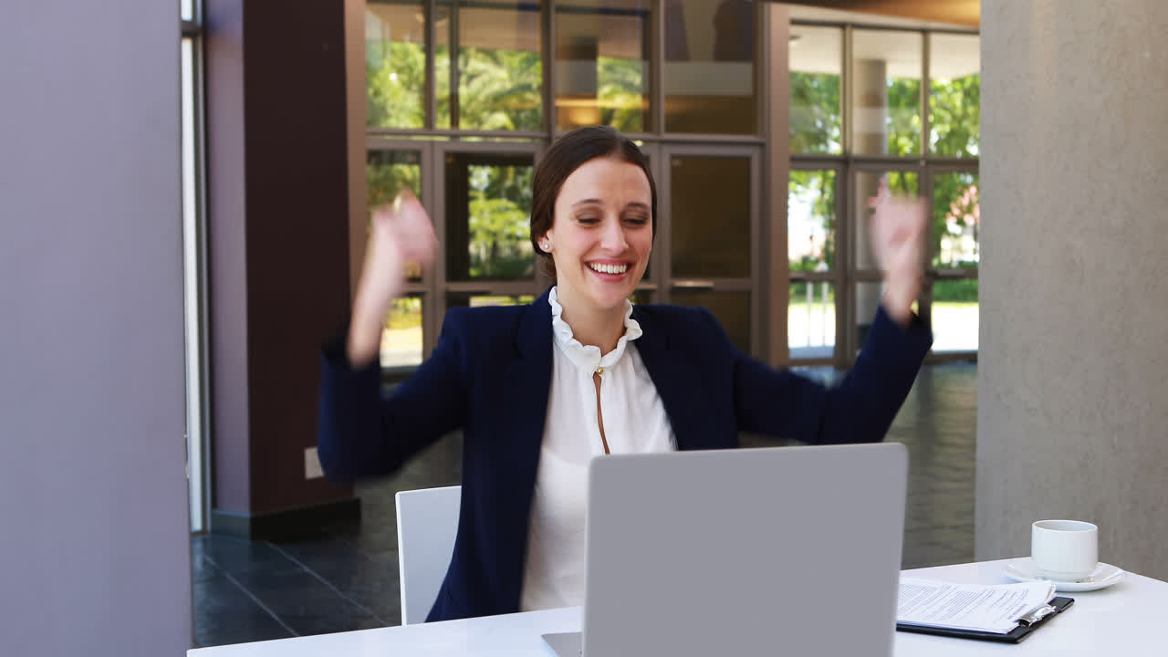 Businesswoman working on laptop at desk 4k