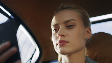 serious woman talking mobile phone at car. business woman making video call.