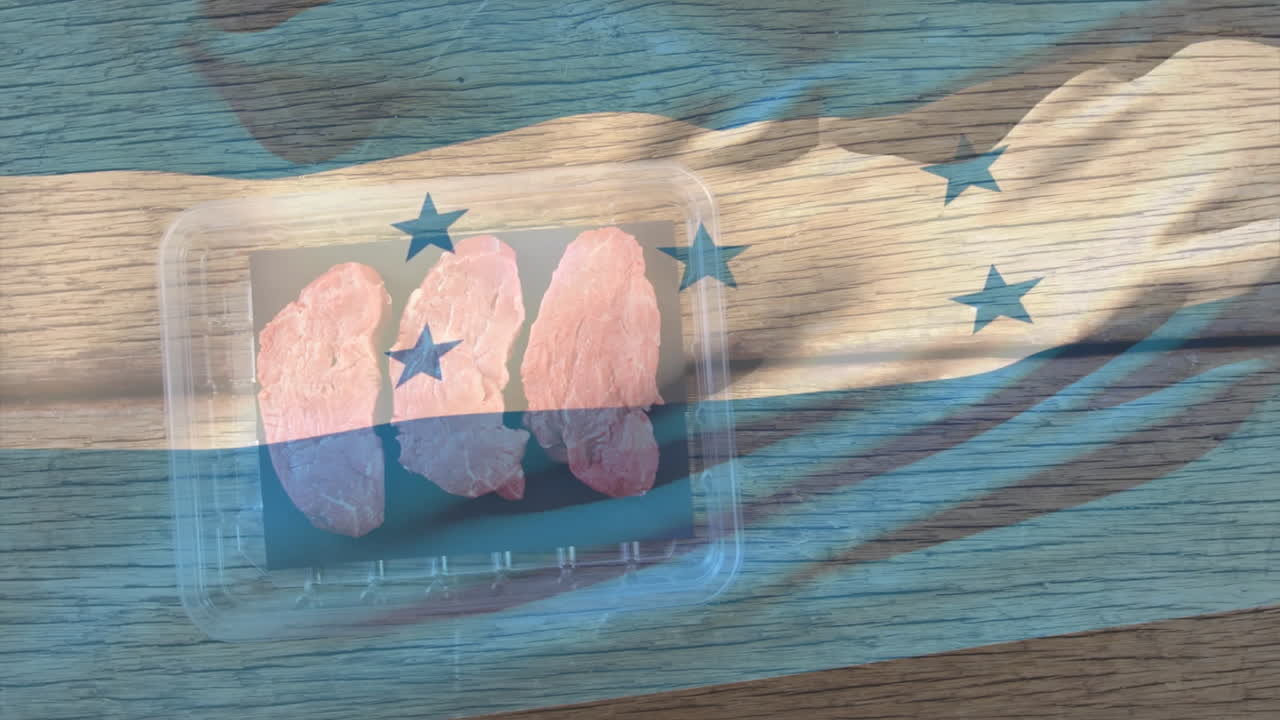 Honduras flag overlaying raw chicken pieces in plastic container on wooden surface