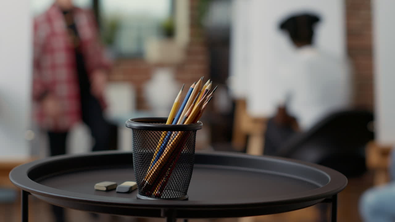 Artistic tools and colorful pencils on table in art class workshop