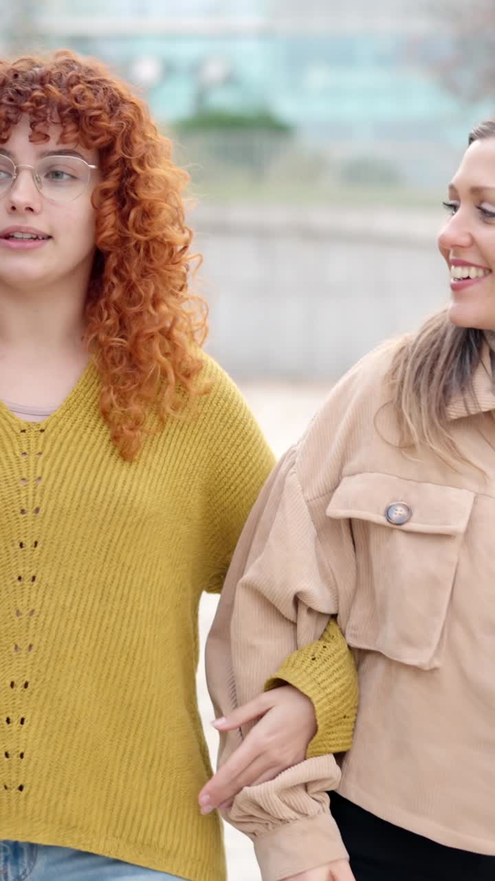 Friends walking relaxed together and talking along the street