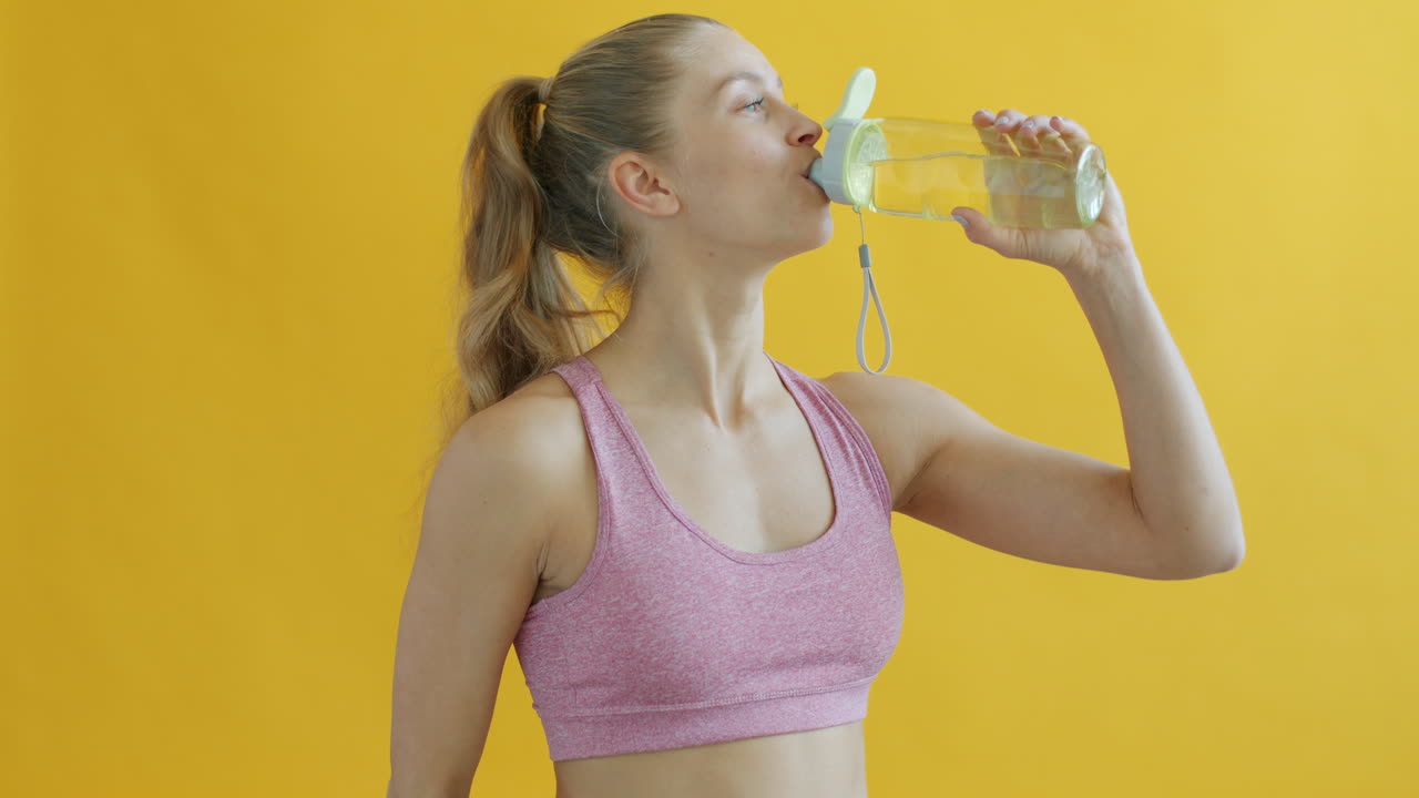 Woman Drinking Water After Exercise