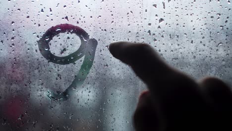 handwritten inscription in english 911 on frosted fogged glass.