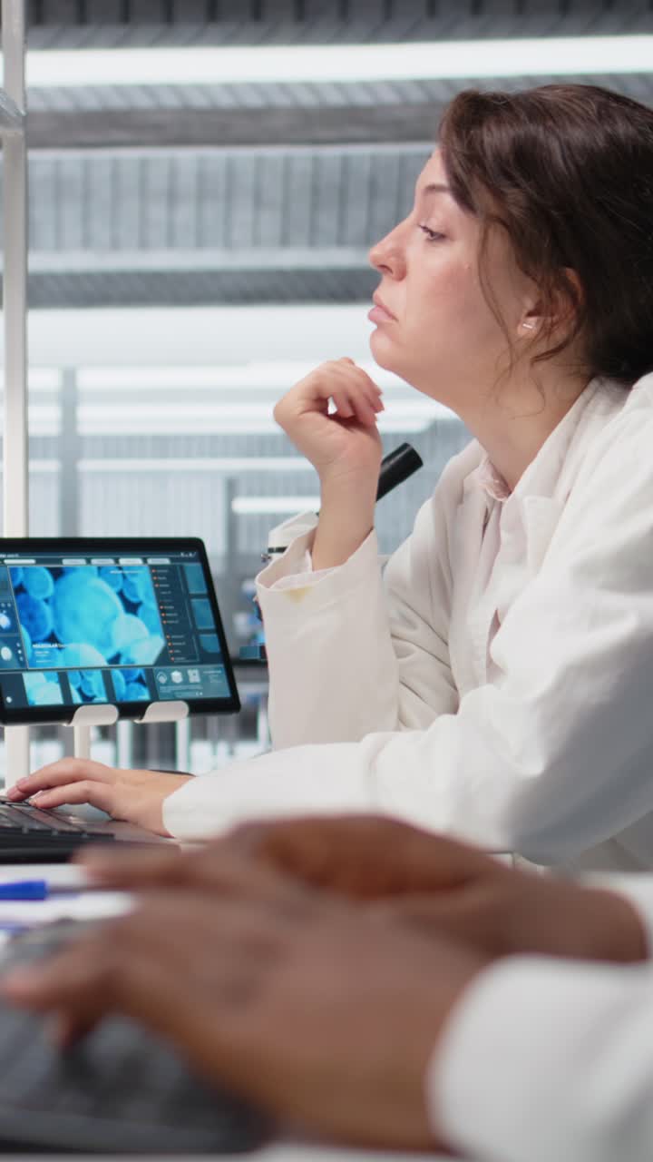 Vertical video Bored medical laboratory technician using computer application