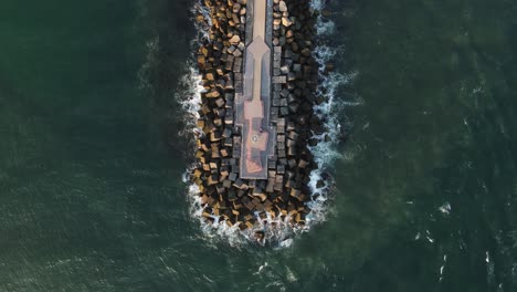 modern coastal promenade out in the ocean built with giant cubed shaped concrete blocks