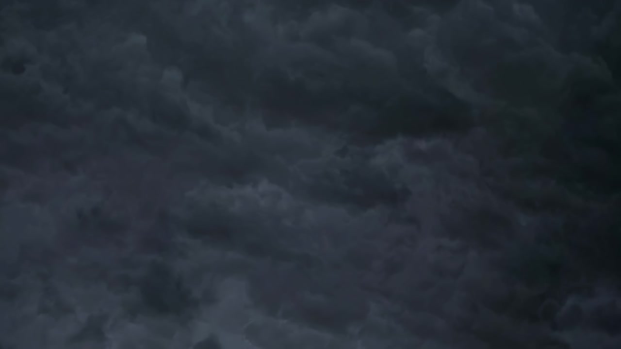 Dramatic video of lightning bolts illuminating dark storm clouds, captured from a low-angle