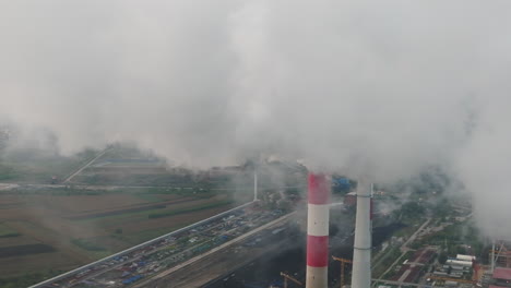 aerial view of power plant with smoke emissions