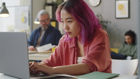 portrait of asian female trainee at work in office