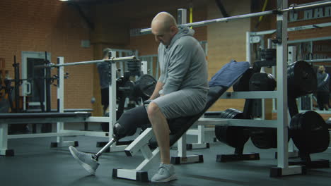 man with a prosthetic leg working out at the gym