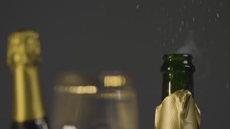 Close-Up-Of-Person-Opening-Bottle-Of-Champagne-At-Table-In-Restaurant