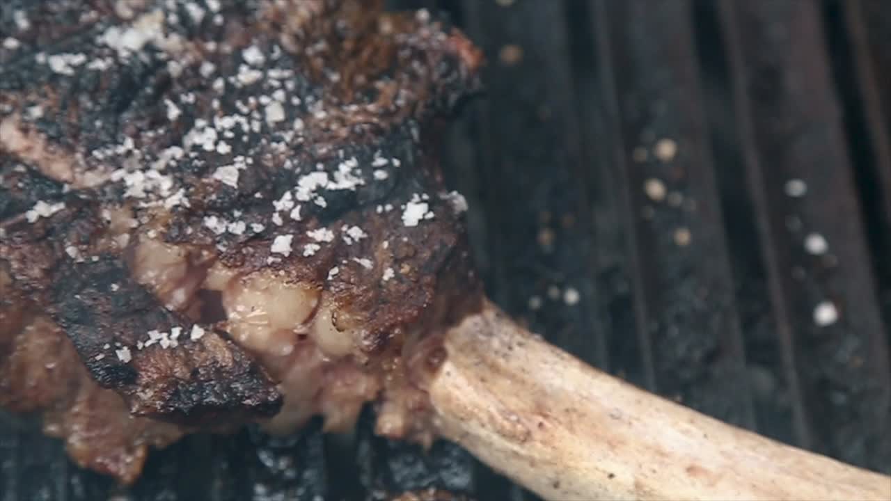 Juicy tomahawk steak on grill