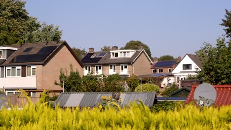 typical 1970's dutch brick houses with solar panels and lush greenery in oosterbeek village